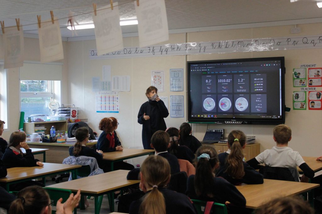 Evelyn gives a talk to the students about displayed weather data coming from their weather station outside