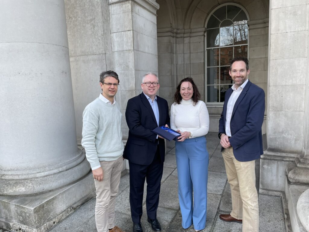 Department of Housing, Local Government & Heritage Secretary General, Graham Doyle, presents the RÉALTA Award to Met Éireann Meteorologist and TRANSLATE project lead, Dr Claire Scannell, alongside Meteorologist, Dr Patrick Fournet (left), and Head of Climate Services Division, Keith Lambkin (right).