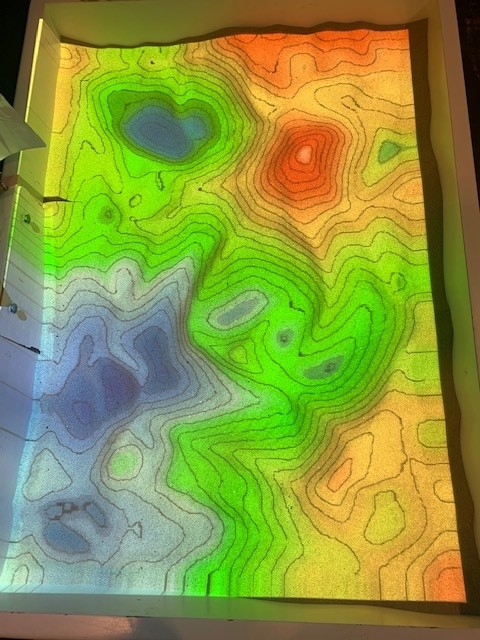 Augmented reality sandbox showing topography and hydrology ( bright colours)